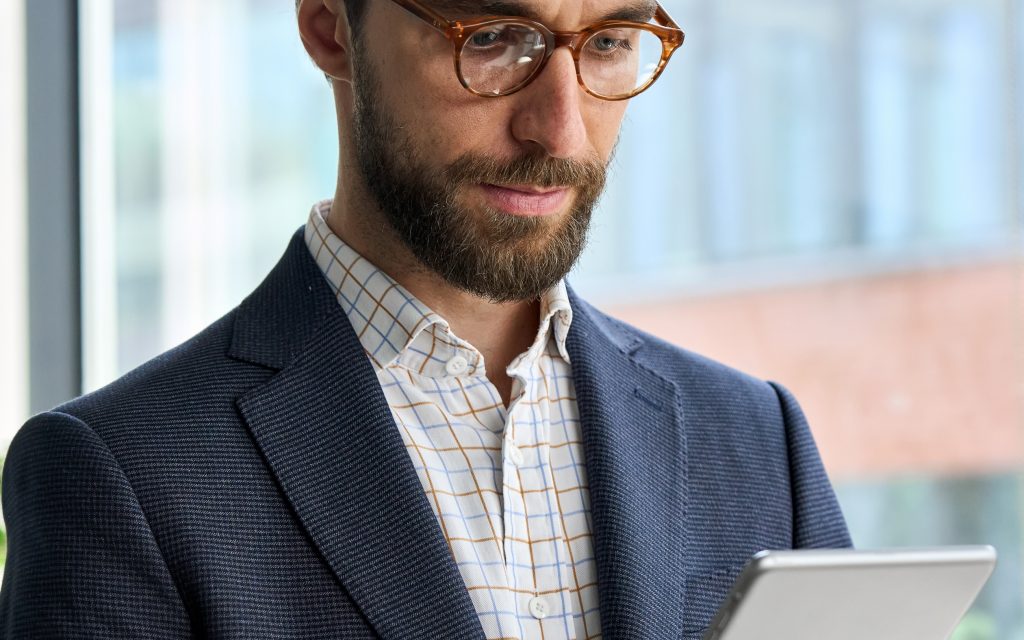 A man looking at a tablet screen.